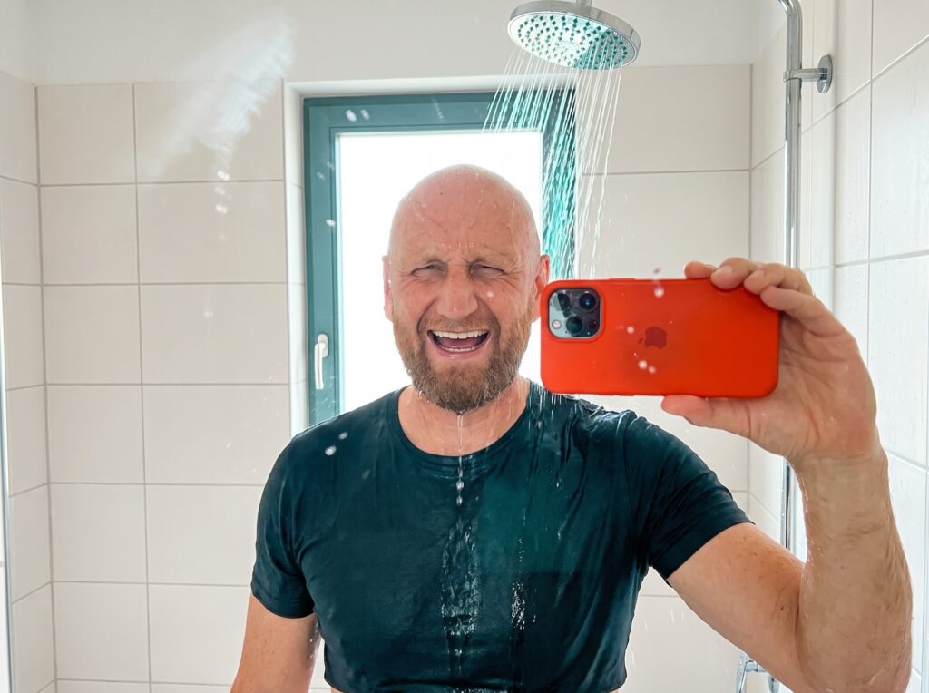 A soaked, grinning cold-shower check-in, phone held up to the mirror: the pact that became Stakes.